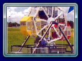 Ferris Wheel - Our Kiddie Ferris Wheel is a great mechanical ride, it is sure to be a hit at your Carnival, Fair, or Festival. Eight to Sixteen children may ride at one time in this colorful Ferris Wheel.  The Ferris Wheel is self contained with four cars and chaser lights that outline the ride.