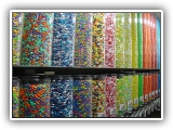 Candy Wall - The candy wall is a main attraction at any type of event. Set ups offer ten different candy choices - all well known brands such as m&m's, candy corns, Gummie Bears and more.. Kids get a small bag to fill with a variety of their favorite treats and take home as a party favor.